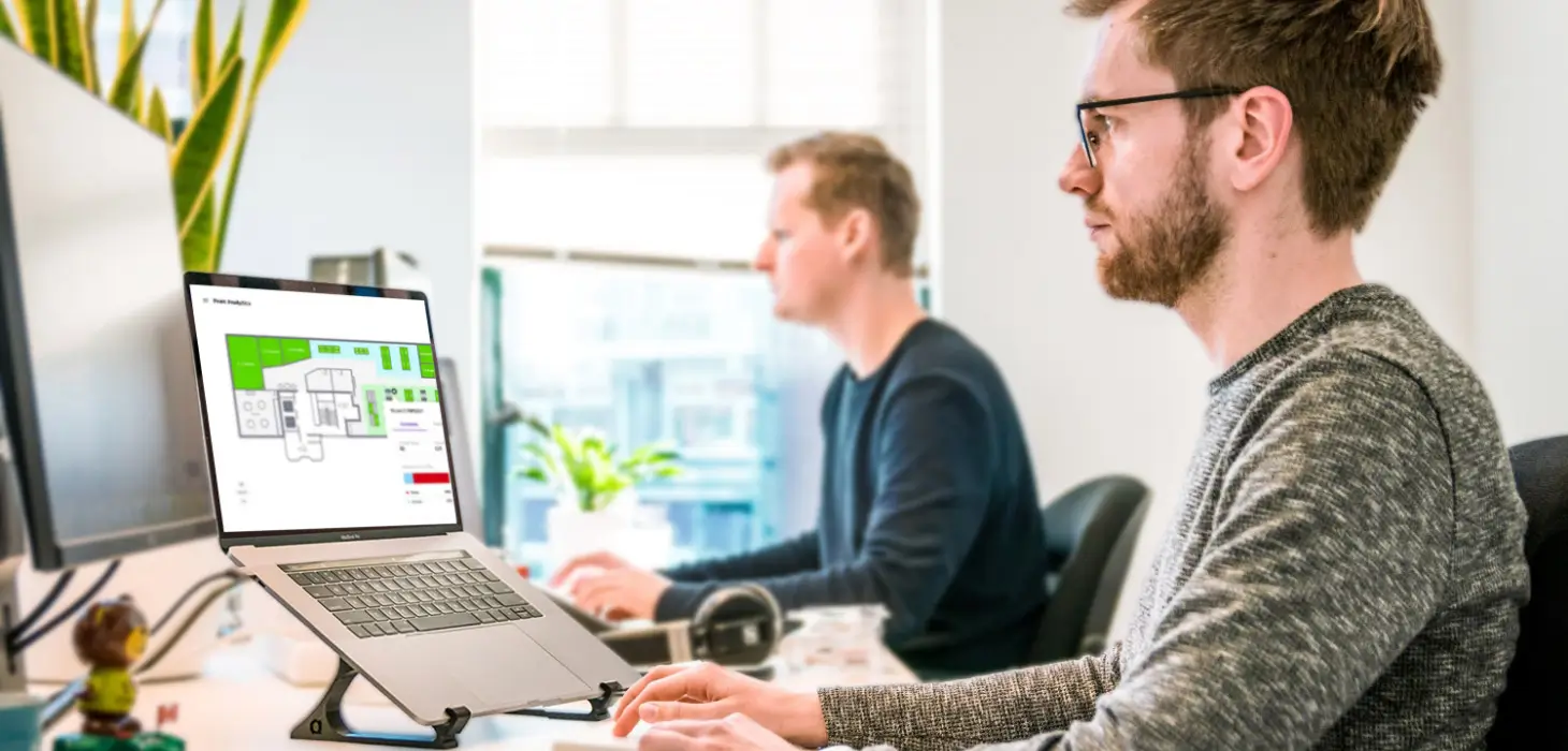 Two males working on laptops