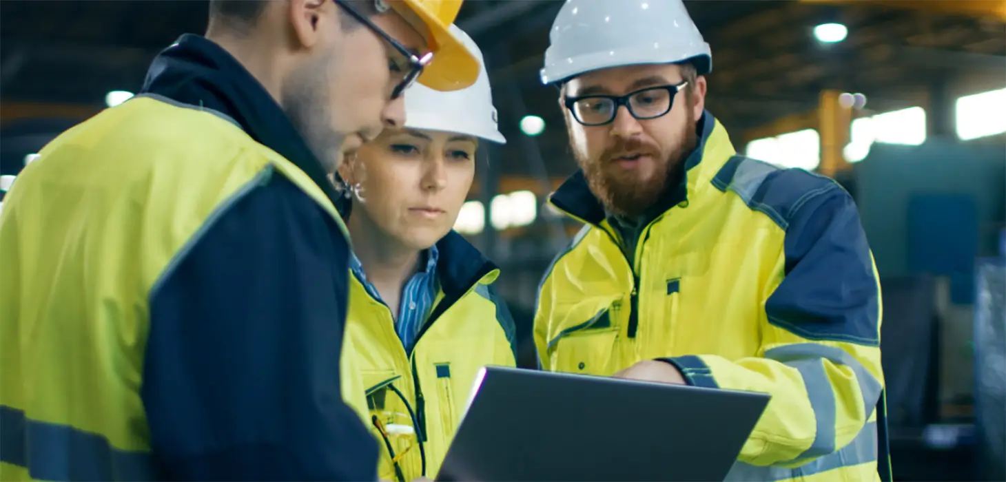 3 warehouse workers look at tablet