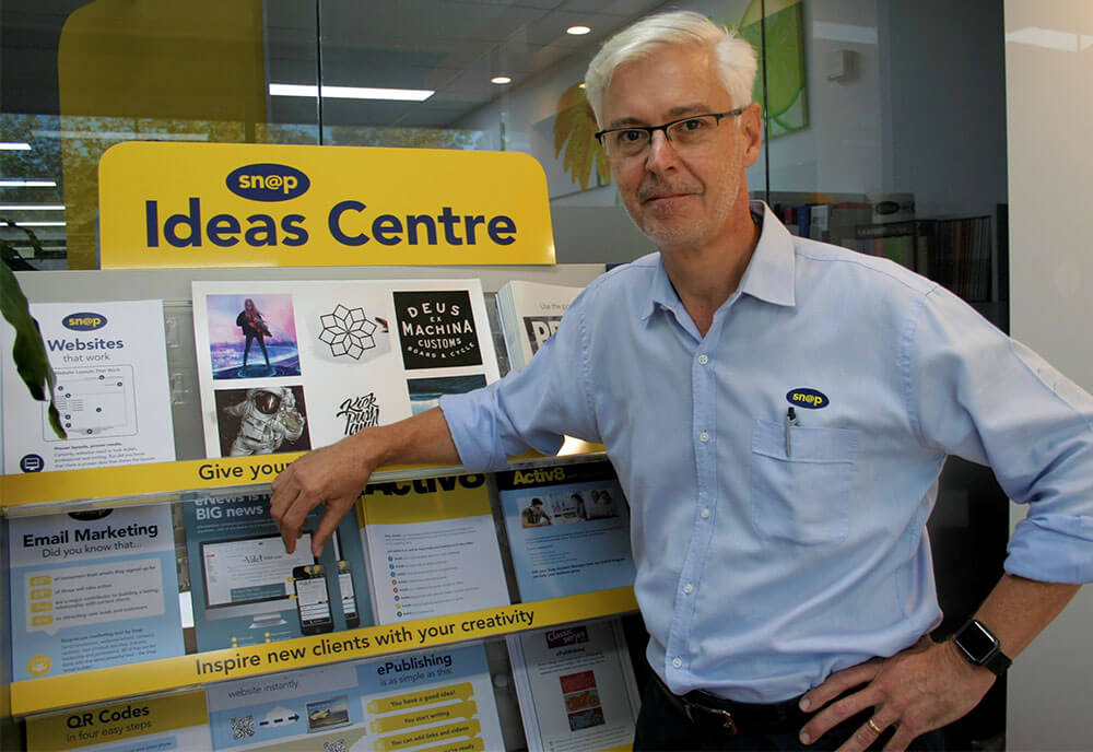 Peter Spencer checks the production schedule on the Ricoh Pro C7200X